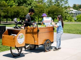 Group of people around a wooden cart