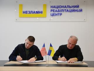 2 people signing documents