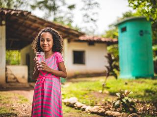 Little girl with glass of water