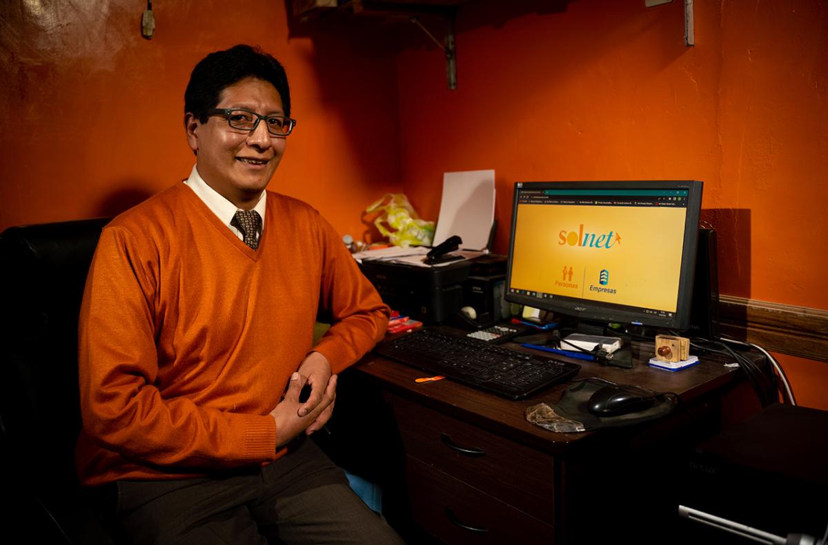 Fernando sitting at a desk with a laptop open to 