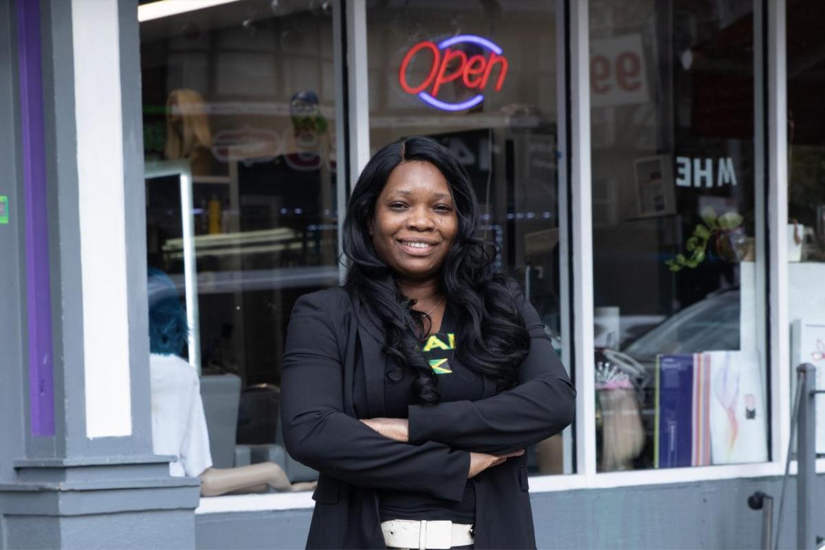 Mitzie outside of a store with a lit 